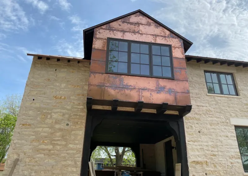 Copper metal panel facade on a stone building for Skylight Installation in Costa Mesa