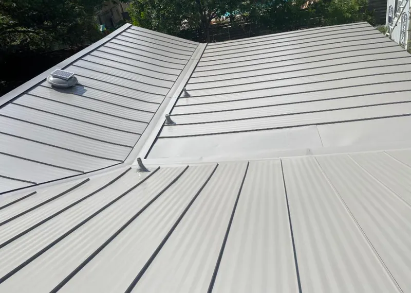 Solar attic fan installed on a metal roof for Roof Ventilation in Costa Mesa